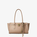 Beige tote bag with gold hardware and tassel charm