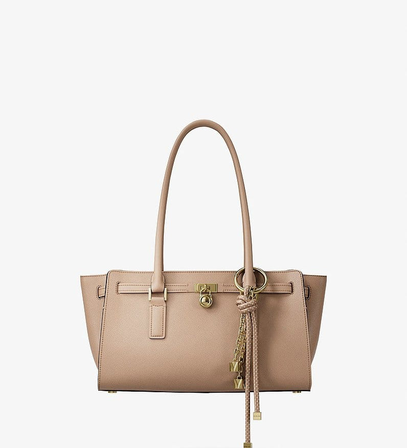 Beige tote bag with gold hardware and tassel charm